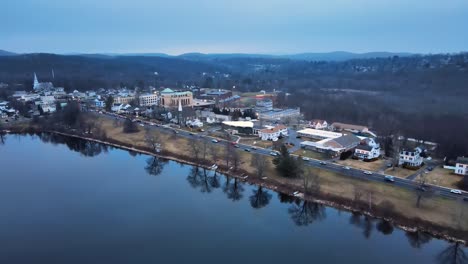 Aerial-footage-approaching-a-small-lake-town-in-america-just-after-sunset