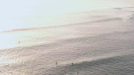 Drone-aerial-surfers-bouncing-on-waves-sunset-Hawaii