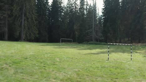 Football-soccer-posts-in-forest-clearing,-remote-mountainside-sport-scene