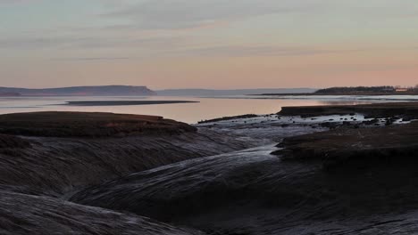 Bay-of-Fundy,-Nova-Scotia-Atlantic-ocean-rising-tide-shoreline-during-sunrise