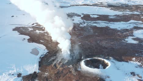 Amazing-volcanic-geyser-emitting-steam,-Gunnuhver-geothermal-field,-aerial