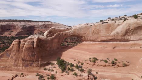 Stunning-View-Of-The-Hole-Of-Wilson-Arch,-A-Red-Geological-Sandstone-Formation-In-The-Desert-Landscape-Of-Moab,-Utah---aerial