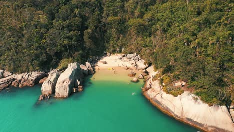 Establishin-shot-sunny-summer-day-tropical-beach-aerial-view-located-in-Santa-Catarina,-Brazil