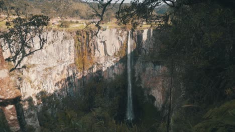 View-through-the-rainforest-of-big-rock-wall-waterfall-in-located-in-Urubici,-Santa-Catarina,-Brazil