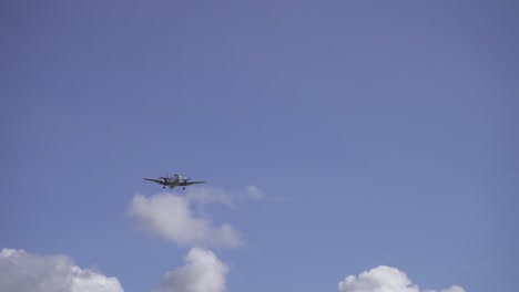 Tacking-shot-footage-of-a-twin-engine-airplane-soaring-under-a-blue-sky