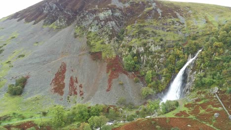 Idyllic-Snowdonia-mountain-range-Aber-falls-waterfalls-national-park-aerial-slow-left-orbit-view