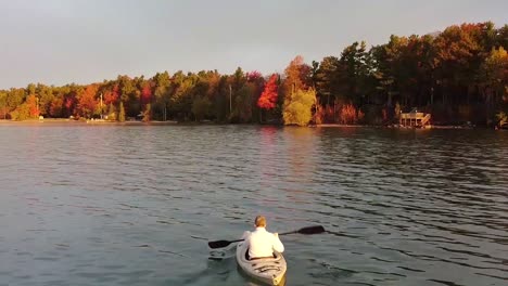 Kayaker-paddling-along-Lake-Michigan-shoreline-during-autumn-colors