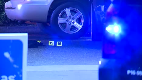 CRIME-SCENE-AT-NIGHT-WITH-FLASHING-LIGHTS-AND-MARKERS