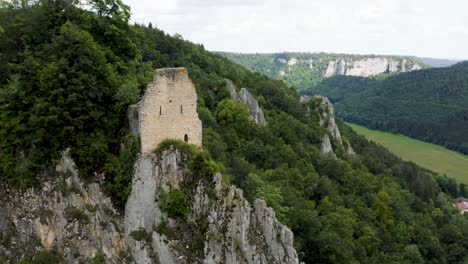 Aerial-of-Castle-Ruin-on-Hill-Surrounded-by-Forest-in-South-Germany
