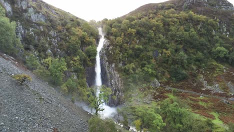 Idyllic-Snowdonia-mountain-range-Aber-falls-waterfalls-national-park-aerial-forward-rising-view