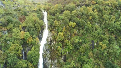 Idyllic-Snowdonia-mountain-range-Aber-falls-waterfalls-national-park-aerial-push-in-view