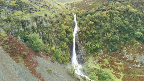 Idyllic-Snowdonia-mountain-range-Aber-falls-waterfalls-national-park-aerial-high-angle-pan-right-view