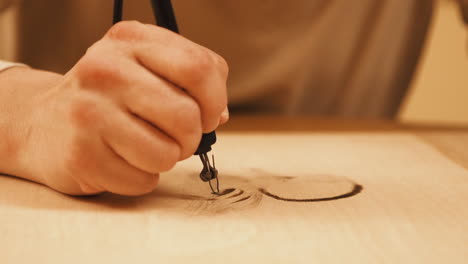 Close-up-footage-of-artist-woodburning-a-duck