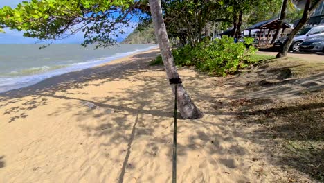 POV-View-Of-Slacklining-On-Beach-With-Ocean-Waves-In-Background