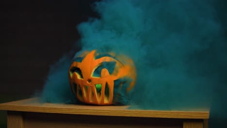 Scary-carved-pumpkin-for-Halloween-have-a-thick-smoke-coming-out-from-the-holes-in-slow-motion