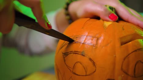 Extreme-close-up-of-cutting-eyebrow-shape-out-of-the-pumpkin-in-slowmotion
