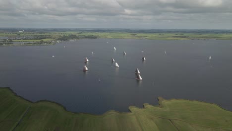 Side-following-shot-of-the-Sneekermeer-on-a-windy-summer-day-with-a-lot-of-big-sailing-boats-on-the-lake