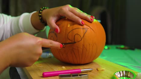 Carving-eye-on-pumpkin-during-thunder-indoor