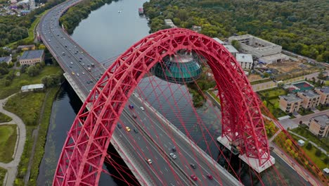 AERIAL-flies-above-the-red-highway-bridge-with-traffic,-Moscow,-Russia