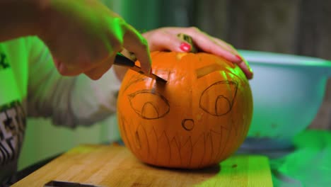 Cutting-out-eyebrow-shape-from-a-pumpkin-in-slowmotion
