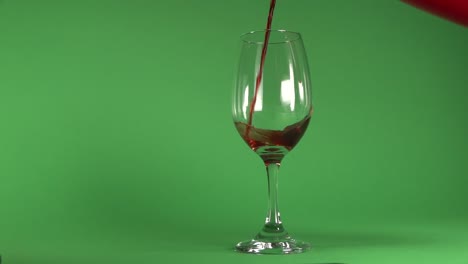 Pouring-wine-on-a-glass,-in-chroma-background