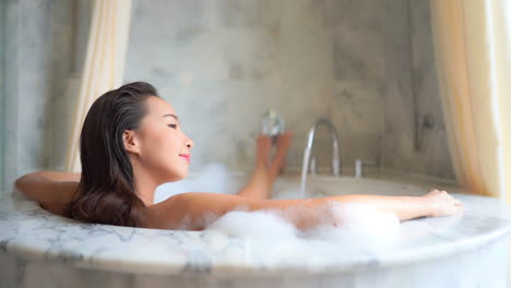 Beautiful-Brunette-Woman-Relaxing-in-Kingsize-Warm-Foamy-Bath-SLOMO