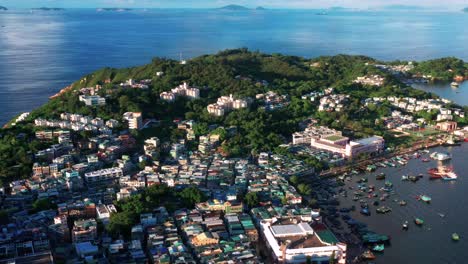Aerial-view-across-Cheung-Chau-tropical-harbour-village-island-Hong-Kong-coastline-dolly-left