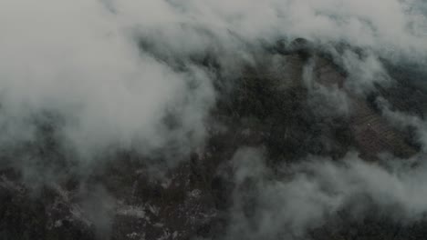 Drone-aerial-flying-over-the-clouds-towards-a-mountian-and-rainforest-in-Guatemala