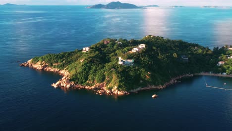 Cheung-Chau-colourful-tropical-island-lush-foliage-aerial-view-orbit-left-around-coastline-ocean-view