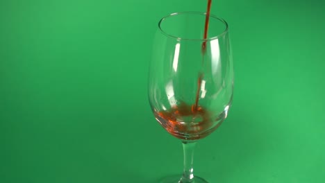 Pouring-wine-on-a-glass,-on-chroma-background