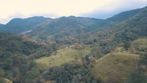 Drone-aerial-rising-shot-of-green-hills-on-a-beautiful-valley-in-Colombia