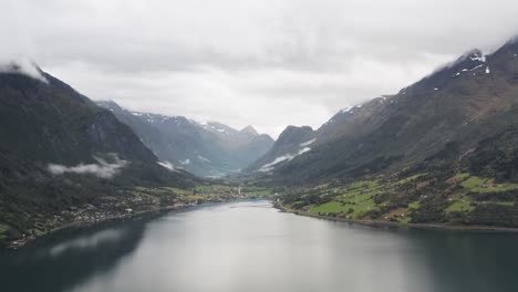 Aerial-View-of-Norwegian-Fjord-and-Coastal-Village-in-a-Valley-On-Misty-Morning