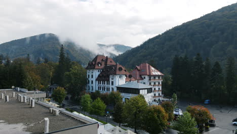 4K-Hyperlapse-Of-An-Hotel-At-The-Base-Of-The-Mountain-Covered-in-Steam-Clouds-And-Fog