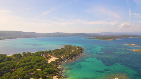 Steady-aerial-drone-clip-over-an-exotic-beach-in-Vourvourou,-Chalkidiki,-Greece