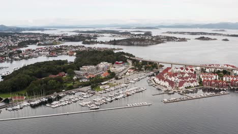 Aerial-View-of-Stavanger-City-Norway-Waterfront,-Grasholmen-Island,-Boats-in-Marina-and-Bybrua-Road-Overpass,-Drone-Shot