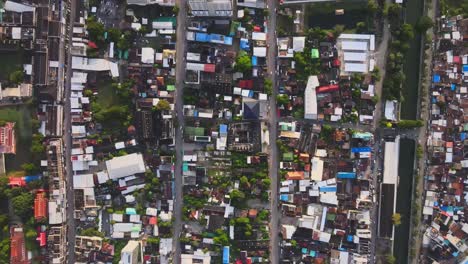 AERIAL:-Drone-flies-forward-high-above-Residential-Blocks-Separated-by-Streets-in-Densely-Populated-Nakhon-Ratchasima-Town-in-Korat-Province,-Thailand
