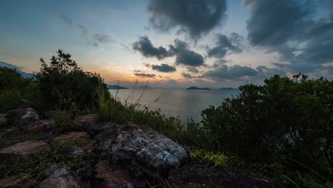 Dramatic-relaxing-red-sunrise-cloudy-sky-over-Lantau-island-Hillside-Hong-Kong-coastal-ocean-landscape