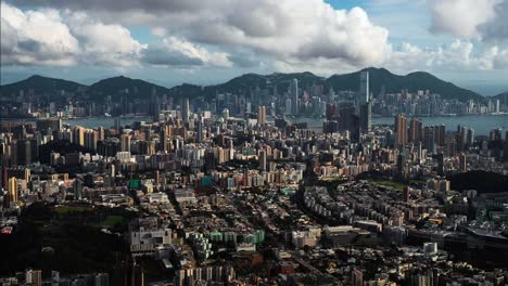 Dramatic-clouds-timelapse-casting-shadows-across-Kowloon-Hong-Kong-downtown-city-view-skyline