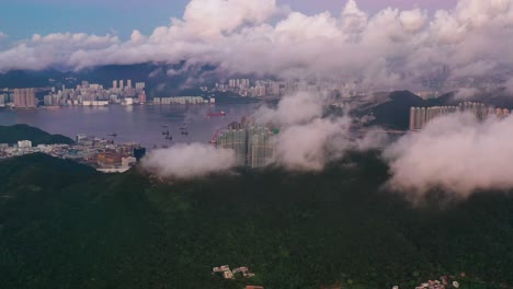 Aerial-view-passing-clouds-over-beautiful-tropical-clear-water-bay-Hong-Kong-coastal-island-skyscrapers-skyline