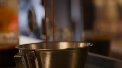 Close-up-of-a-double-espresso-pouring-from-the-machine-at-a-coffee-shop