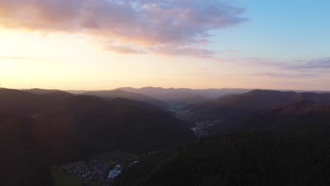 Drone-flying-forward-above-valley-inbetween-mountains-in-Black-Forest,-Germany-in-4k