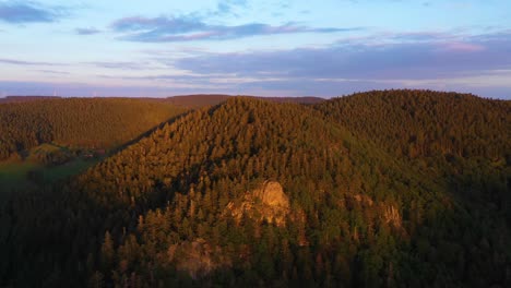 Drone-spinning-around-mountains-with-huge-ledge-in-Black-Forest,-Germany-in-4k