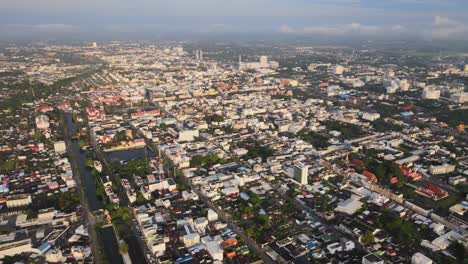 AERIAL:-Drone-Panning-Left-to-Right-high-above-Densely-Populated-Nakhon-Ratchasima-Town-in-Korat-Province,-Thailand