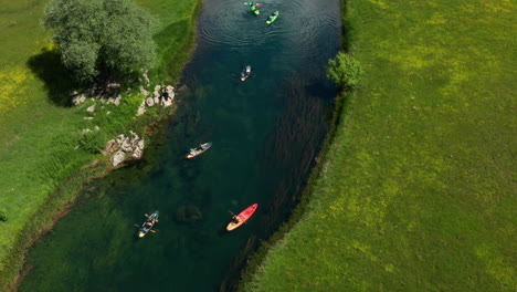 Kayaks-journey-down-Gacka-River,-Lika-Region-Aerial-View-of-Croatia