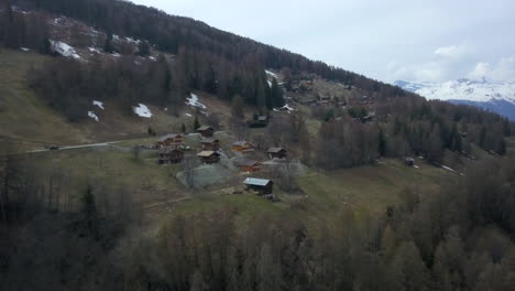 Aerial-view-pulling-back-from-log-cabins-in-Swiss-Alps-ski-resort
