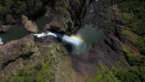 Amazing-waterfall-top-down-aerial-view,-rainbow-in-falls-mist