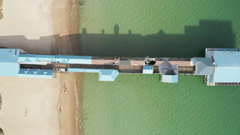 Overhead-shot-of-Old-Orchard-Beach-Maine-Pier-in-green-water