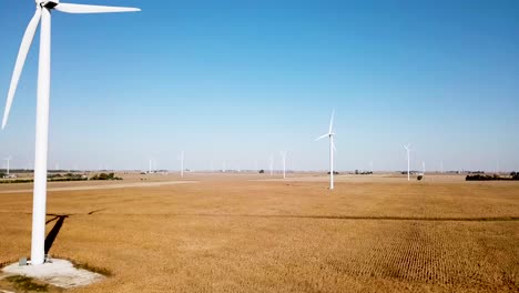 Spinning-Wind-Turbines-Generating-Energy---Electricity---Aerial-Establishing-Drone-View
