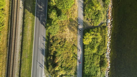 The-Aerial-View-Of-the-Clean-Street-In-Kuznica-Poland-Surrounded-By-Lush-Green-Plants-With-Vehicles-Passing-By---Aerial-Shot