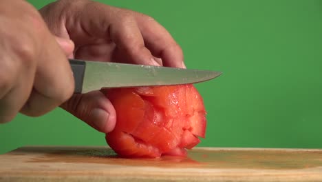 Hands-dicing-a-tomato-on-a-chroma-background